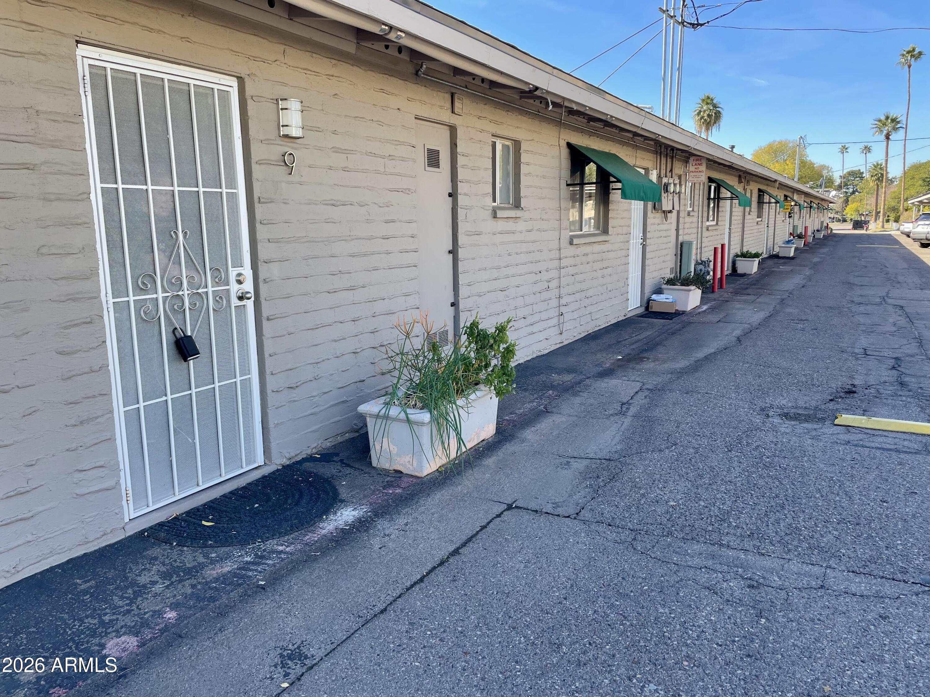 6819 North 12th Street, Unit 9 Phoenix, AZ 85014 - Photo 19 of 21 a view of a house with backyard and wooden fence