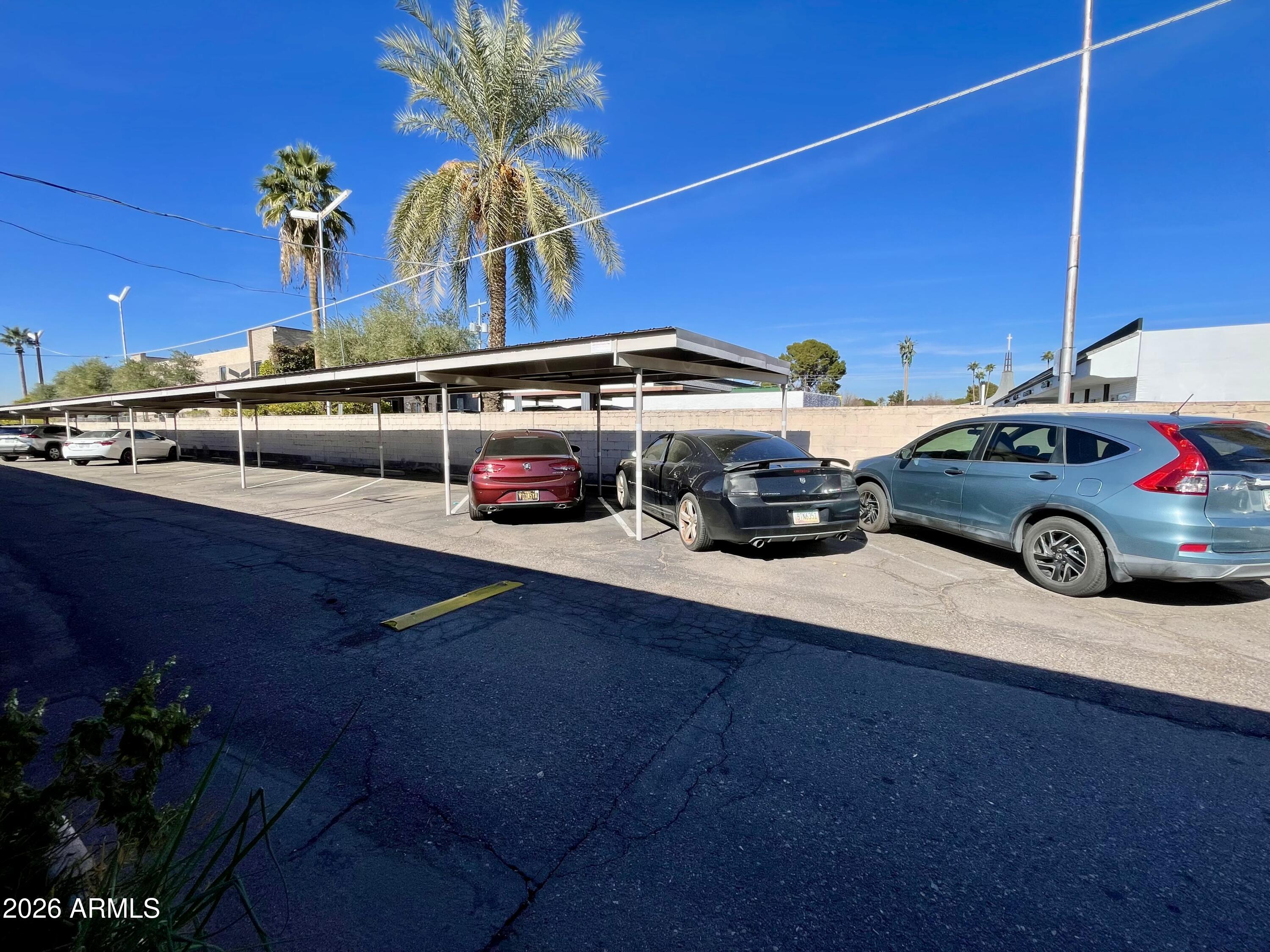 6819 North 12th Street, Unit 9 Phoenix, AZ 85014 - Photo 20 of 21 a front view of a house with parking space