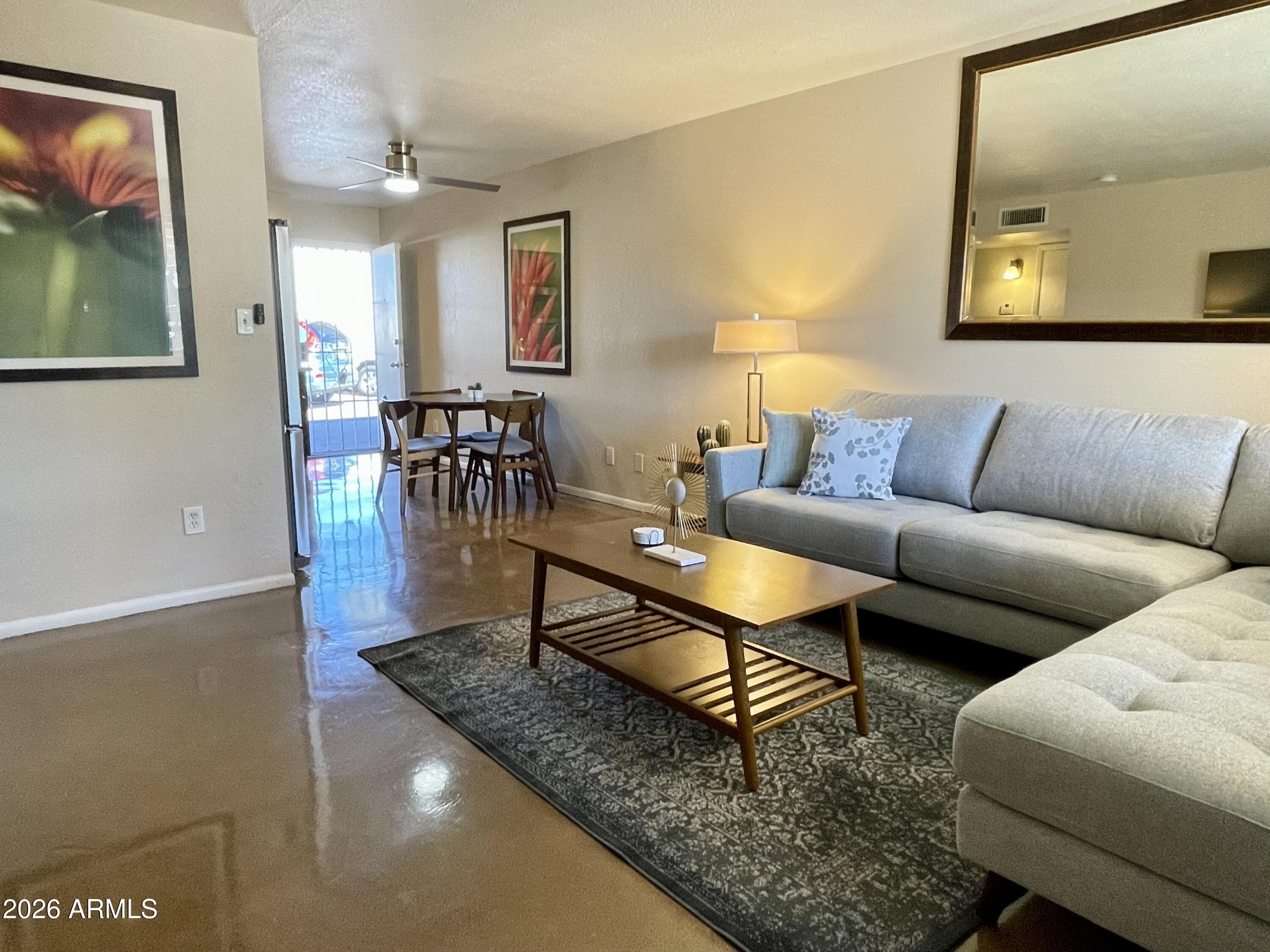6819 North 12th Street, Unit 9 Phoenix, AZ 85014 - Photo 2 of 21 a living room with furniture and a couch