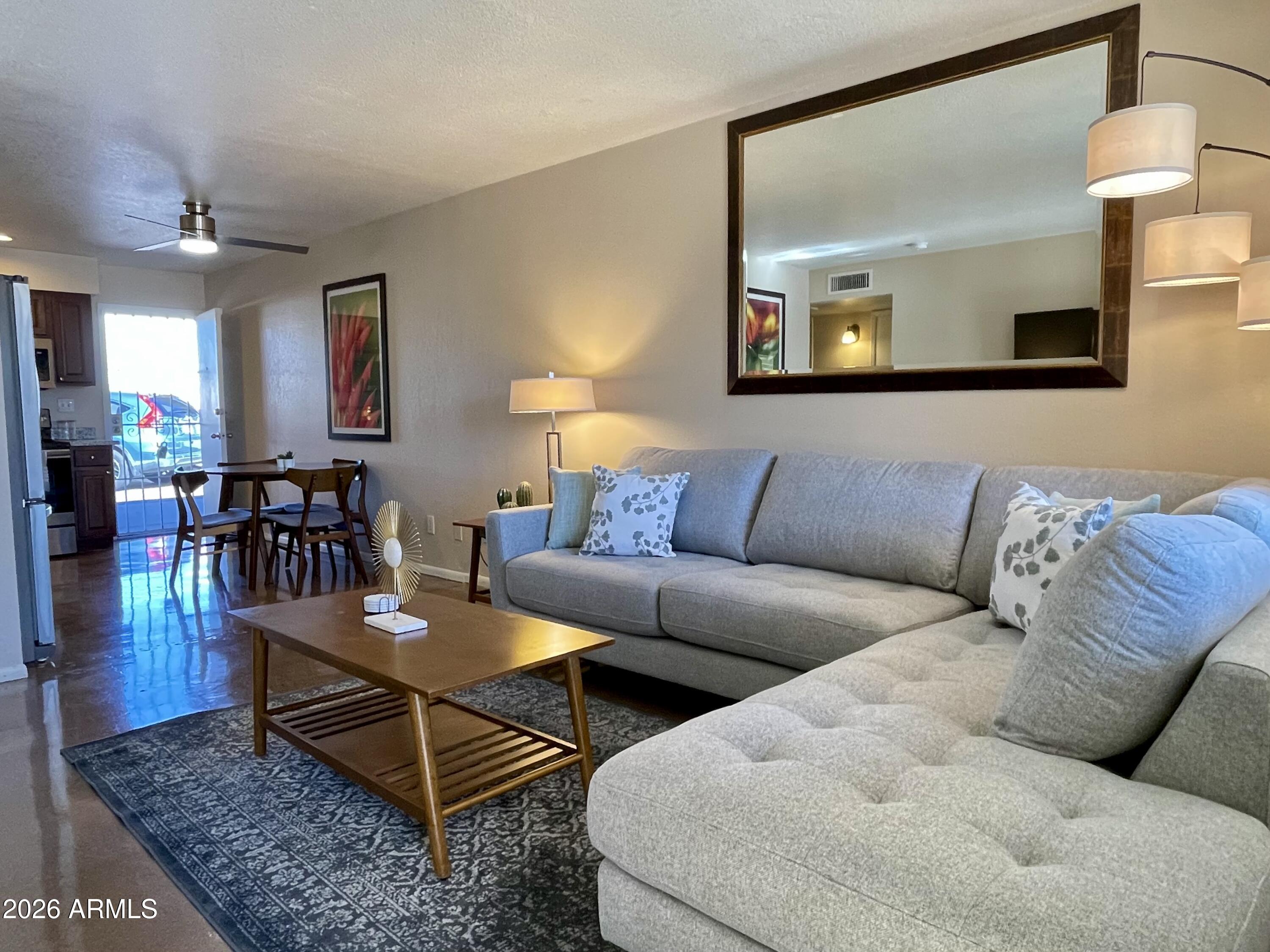 6819 North 12th Street, Unit 9 Phoenix, AZ 85014 - Photo 3 of 21 a living room with furniture and wooden floor
