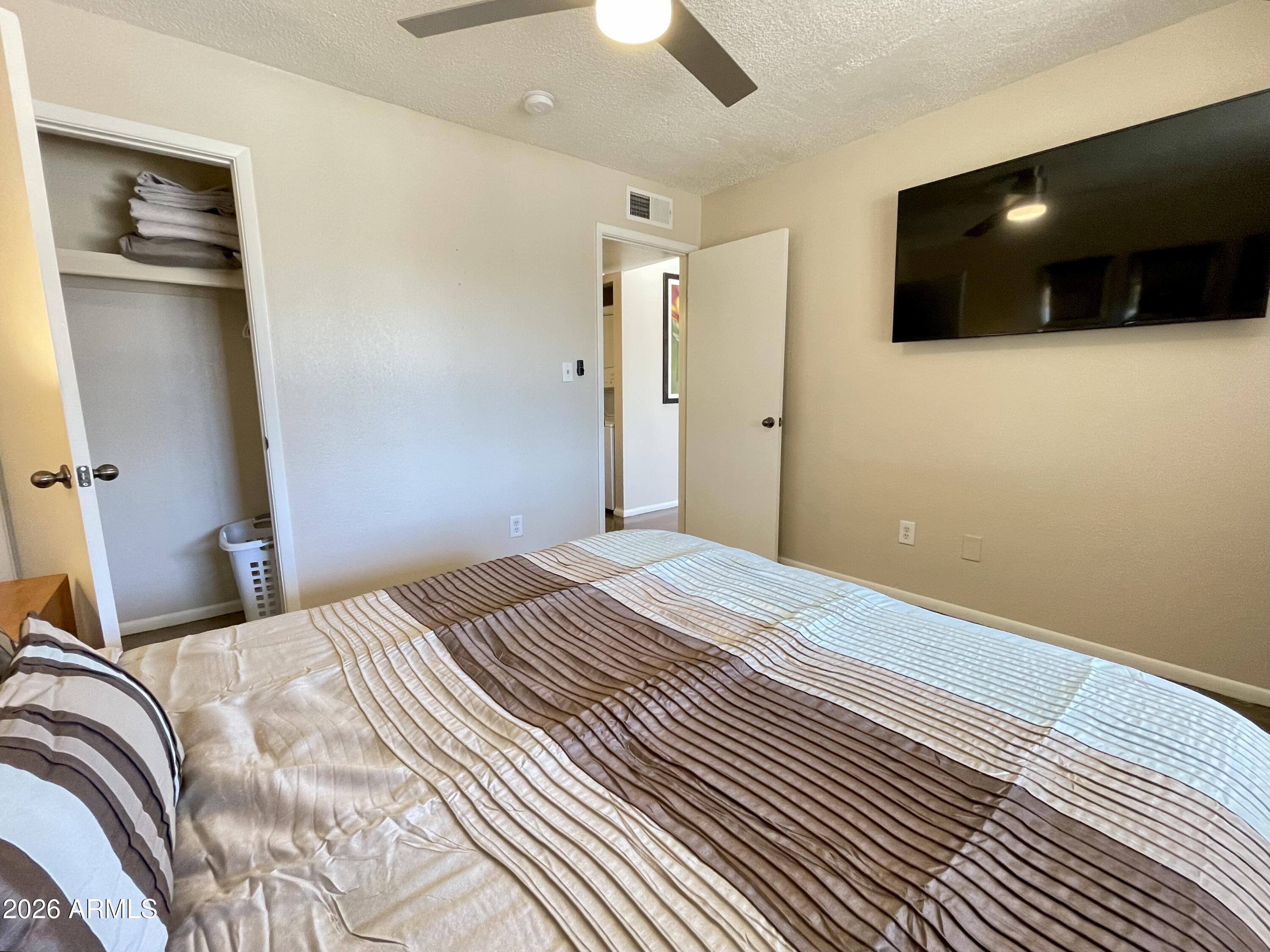 6819 North 12th Street, Unit 9 Phoenix, AZ 85014 - Photo 8 of 21 a bedroom with a bed and a flat screen tv