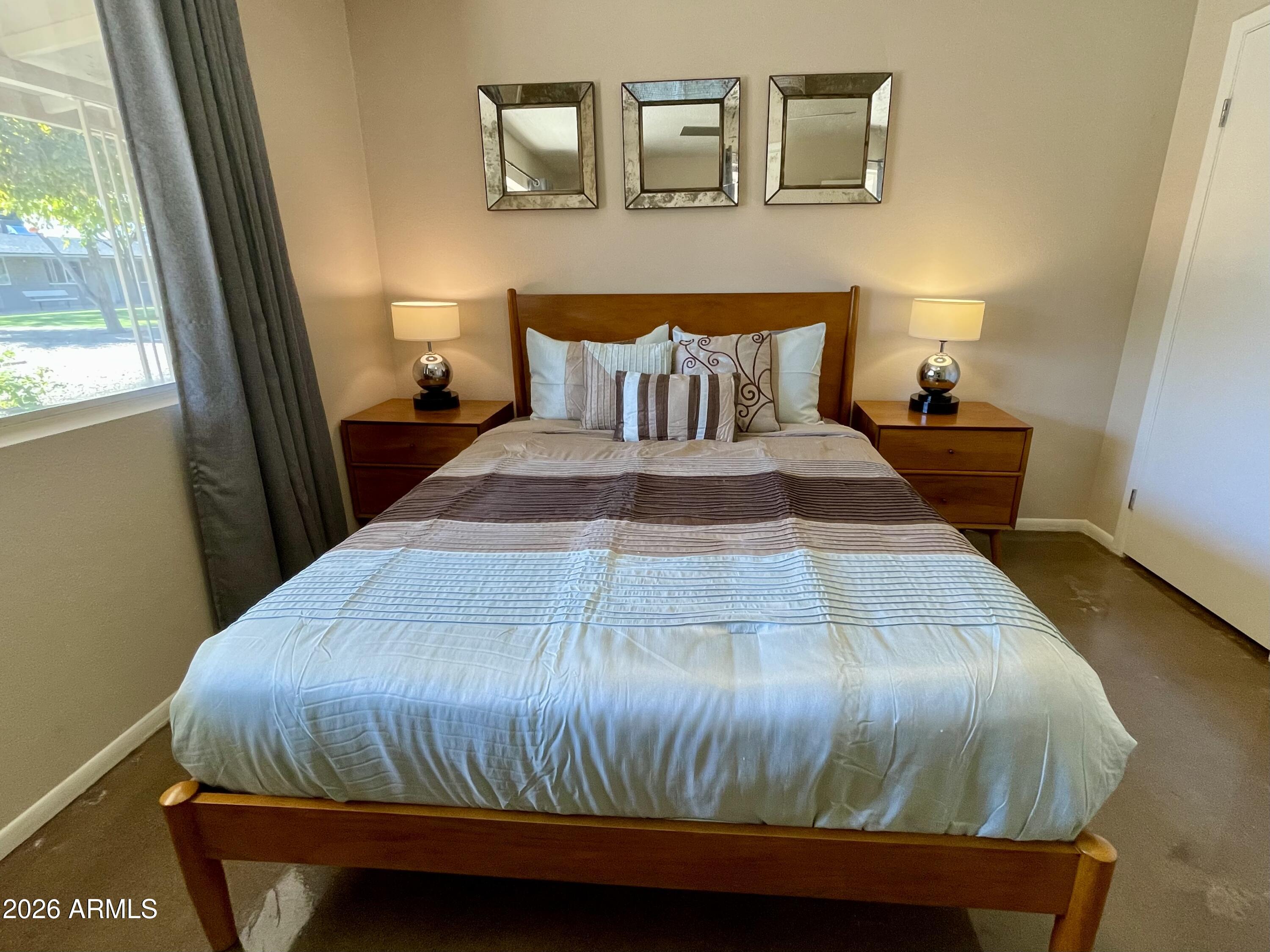 6819 North 12th Street, Unit 9 Phoenix, AZ 85014 - Photo 9 of 21 a bedroom with a bed and window