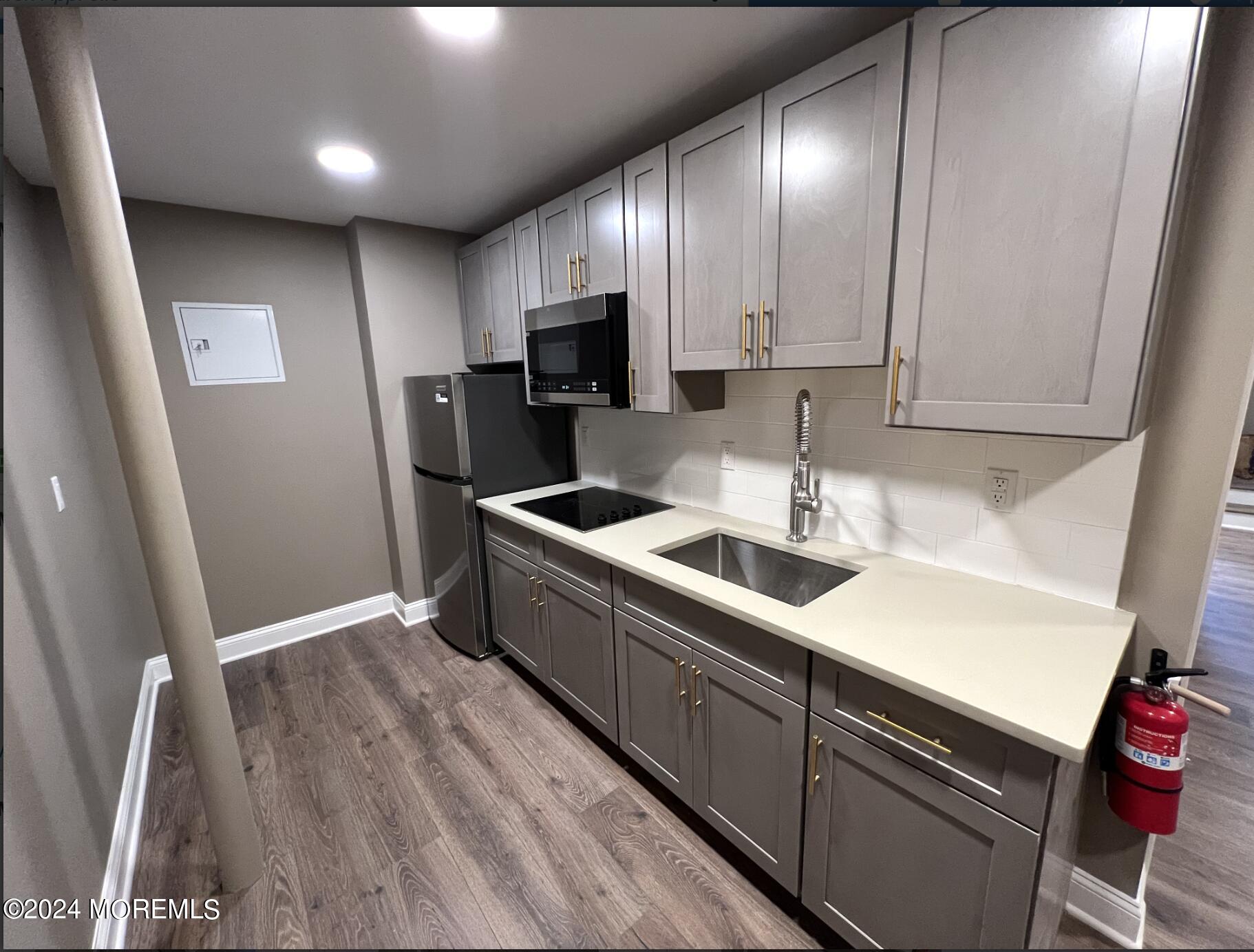 182-192 Broad Street, Unit 3 Red Bank, NJ 07701 - Photo 1 of 8 a kitchen that has a sink stainless steel appliances a counter space and cabinets