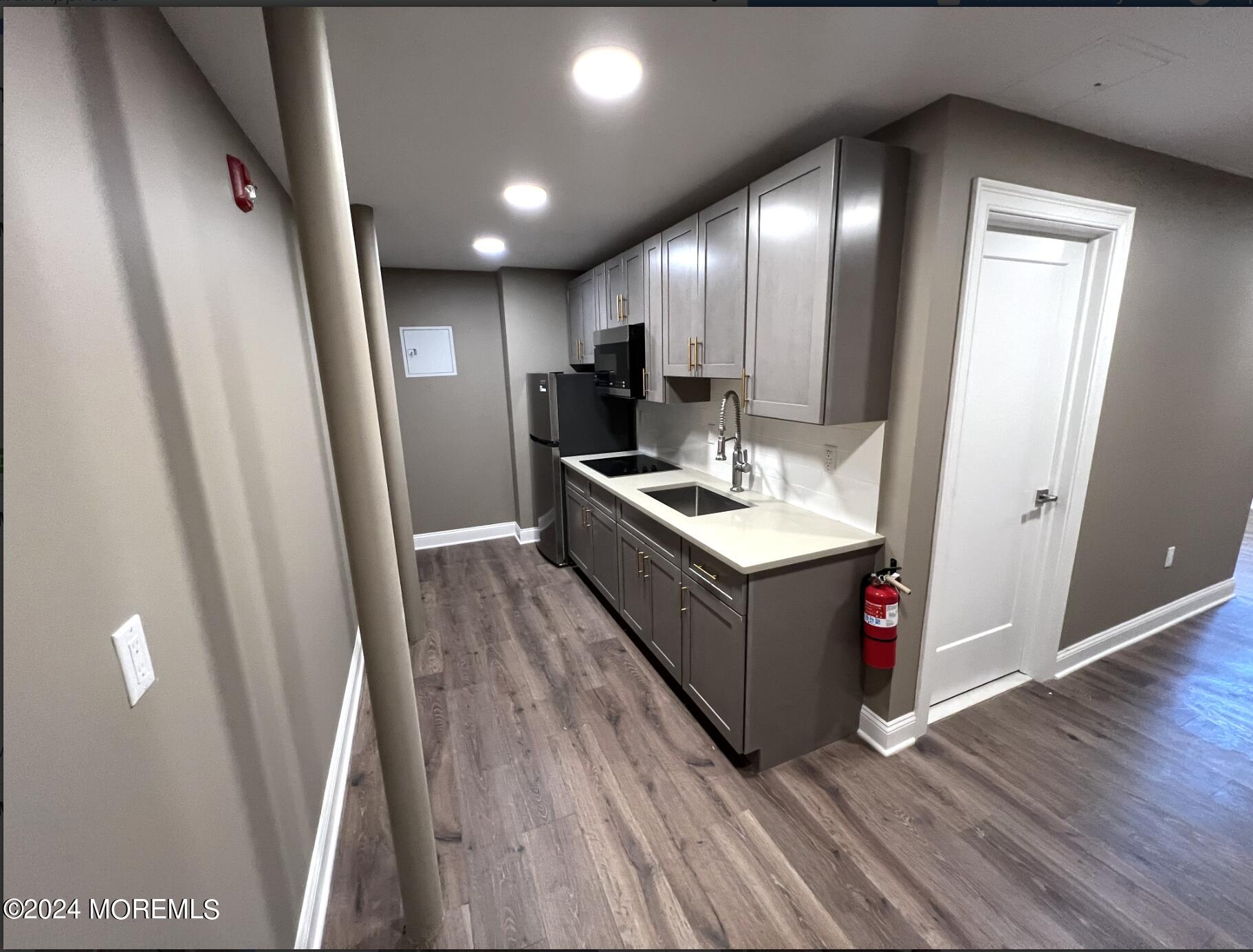 182-192 Broad Street, Unit 3 Red Bank, NJ 07701 - Photo 7 of 8 a kitchen with sink a refrigerator and wooden floor