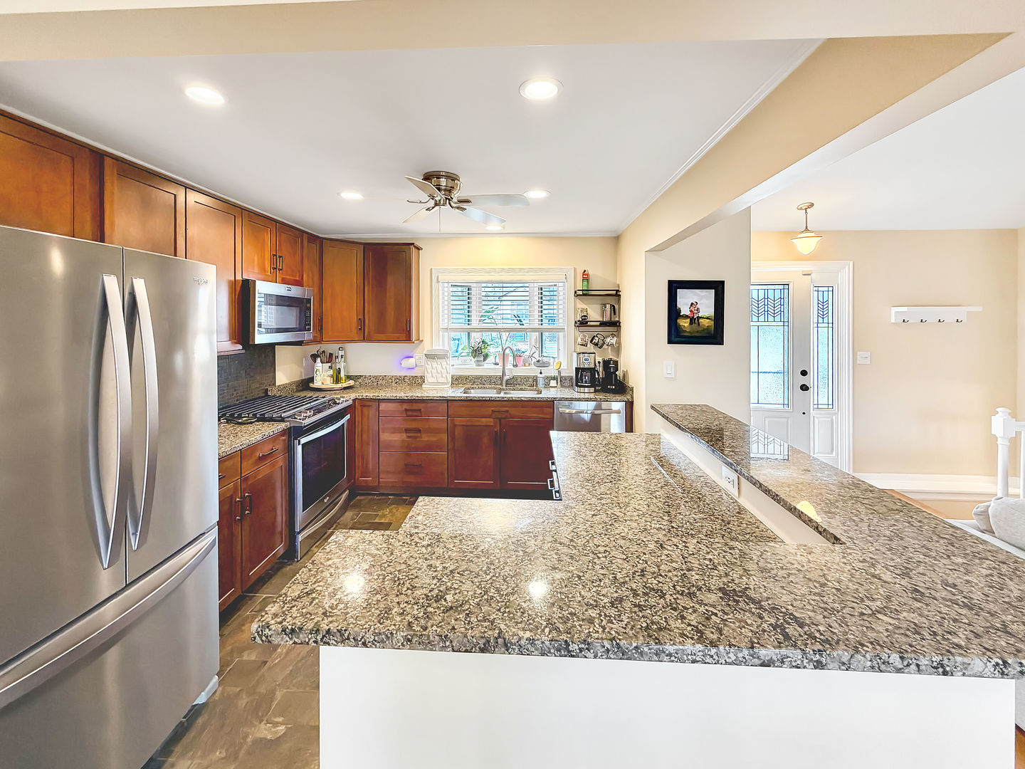 104 McClellan Street Bartlett, IL 60103 - Photo 7 of 21 a large kitchen with kitchen island granite countertop wooden cabinets a granite counter tops and a stove