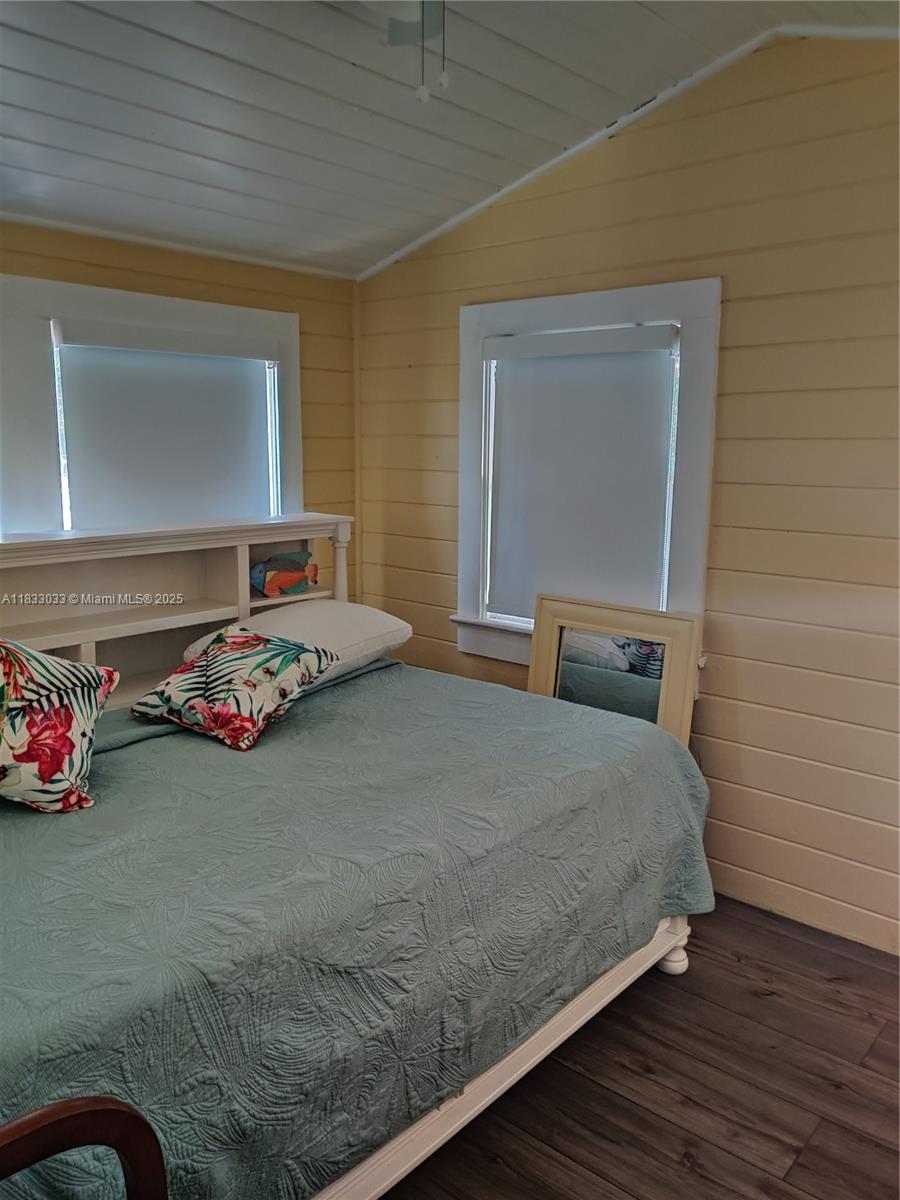 16475 Southwest 248th Street, Unit 16475 Homestead, FL 33031 - Photo 7 of 8 a bedroom with a bed and a dresser next to a window