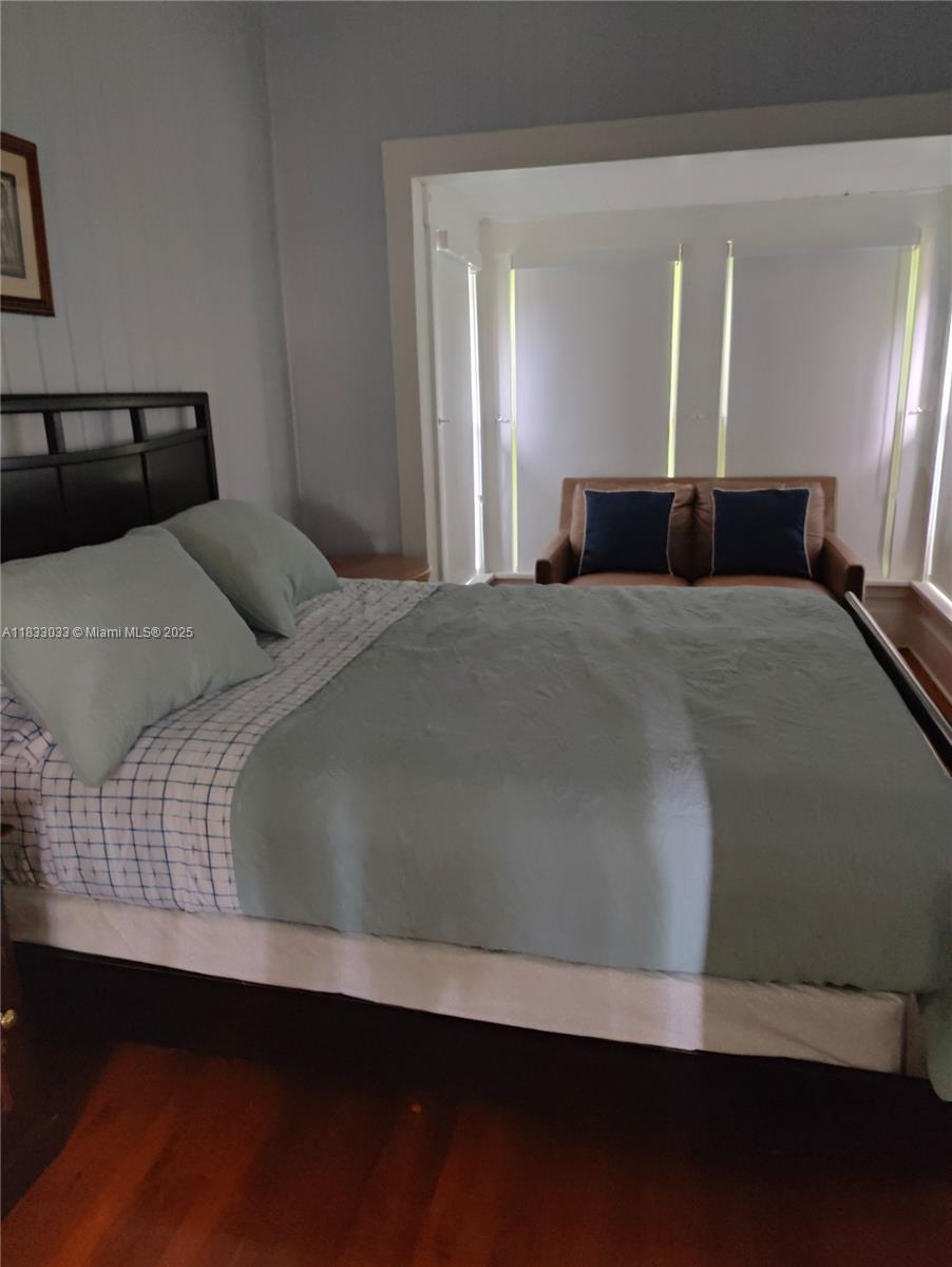 16475 Southwest 248th Street, Unit 16475 Homestead, FL 33031 - Photo 8 of 8 a bedroom with bed and window