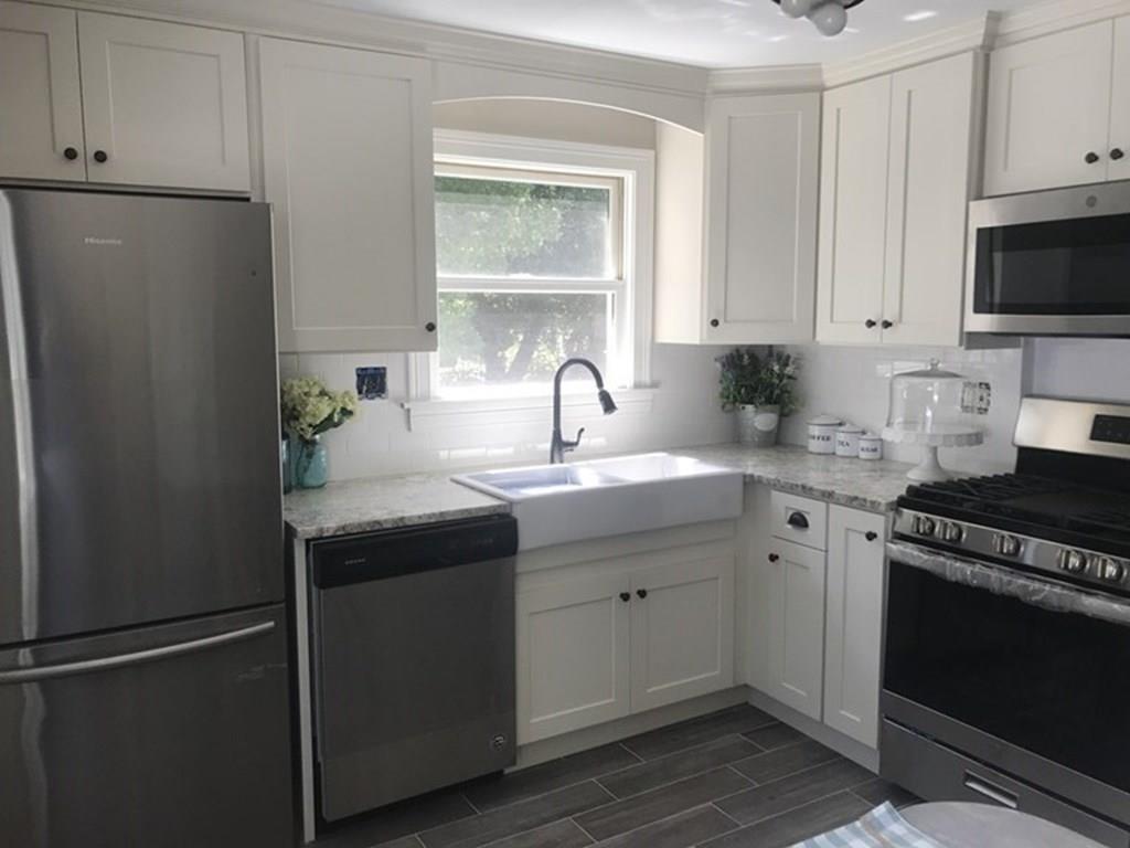 33 Surrey Road Springfield, MA 01118 - Photo 3 of 22 a kitchen with a sink and a refrigerator