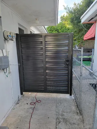 a view of a backyard with wooden fence