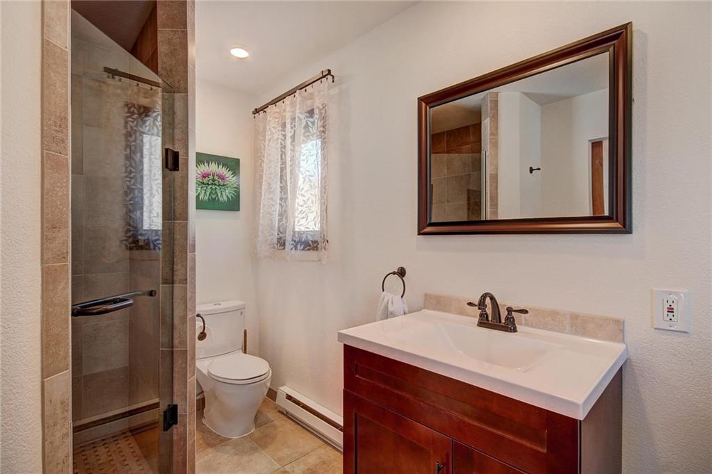 187 Rasor Drive Keystone, CO 80435 - Photo 18 of 24 a bathroom with a toilet sink and mirror