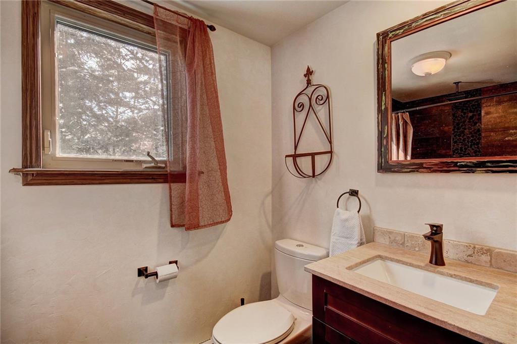 187 Rasor Drive Keystone, CO 80435 - Photo 6 of 24 a bathroom with a toilet sink and mirror