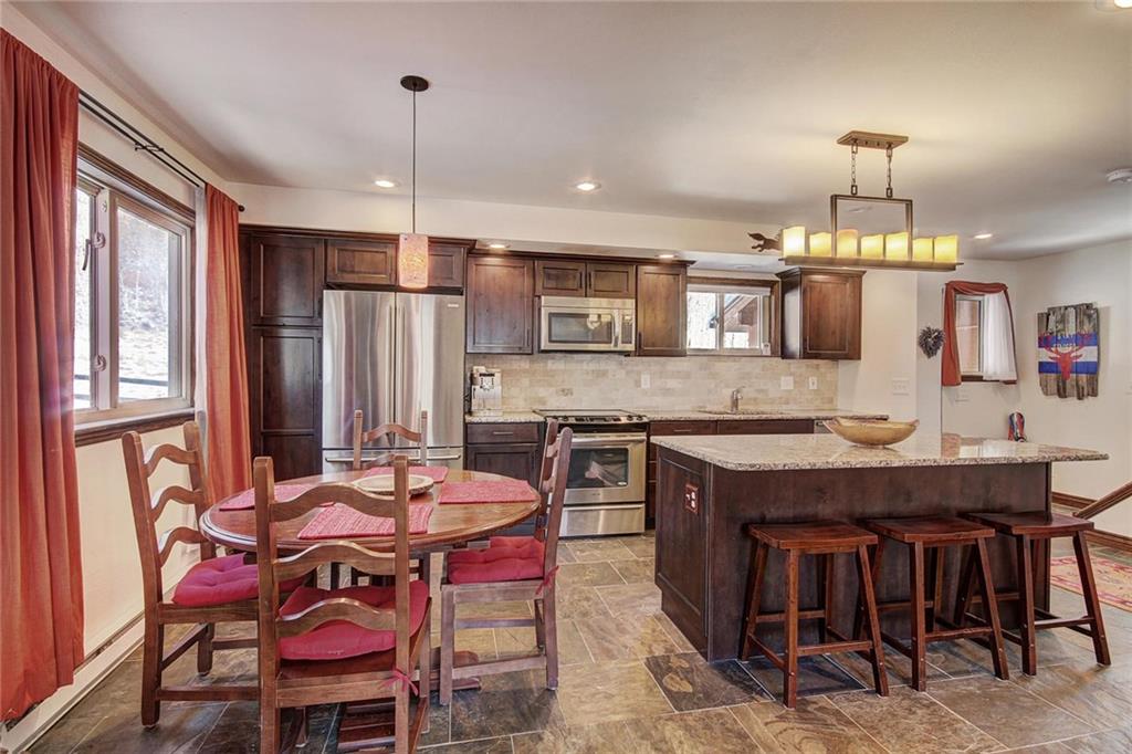 187 Rasor Drive Keystone, CO 80435 - Photo 10 of 24 a kitchen with granite countertop a table chairs stove and refrigerator