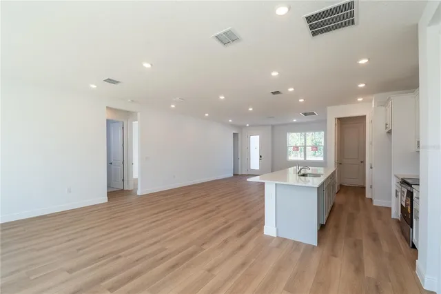 a view of a kitchen with sink and a refrigerator
