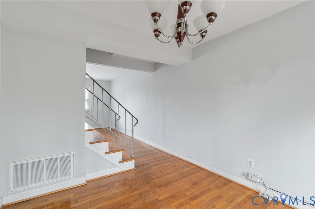 3109 North Parham Road, Unit 17 Henrico, VA 23294 - Photo 12 of 22 Stairs with a chandelier and wood-type flooring