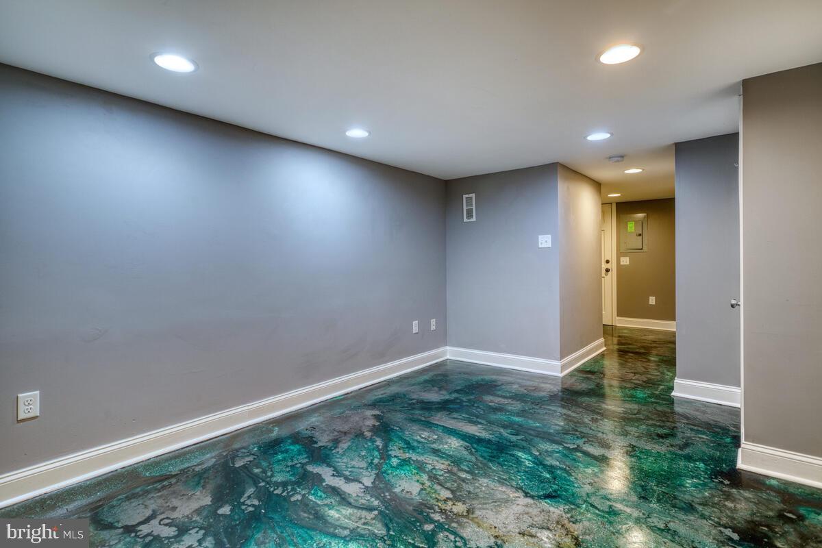 340 Gusryan Street Baltimore, MD 21224 - Photo 22 of 34 an empty room with wooden floor and windows