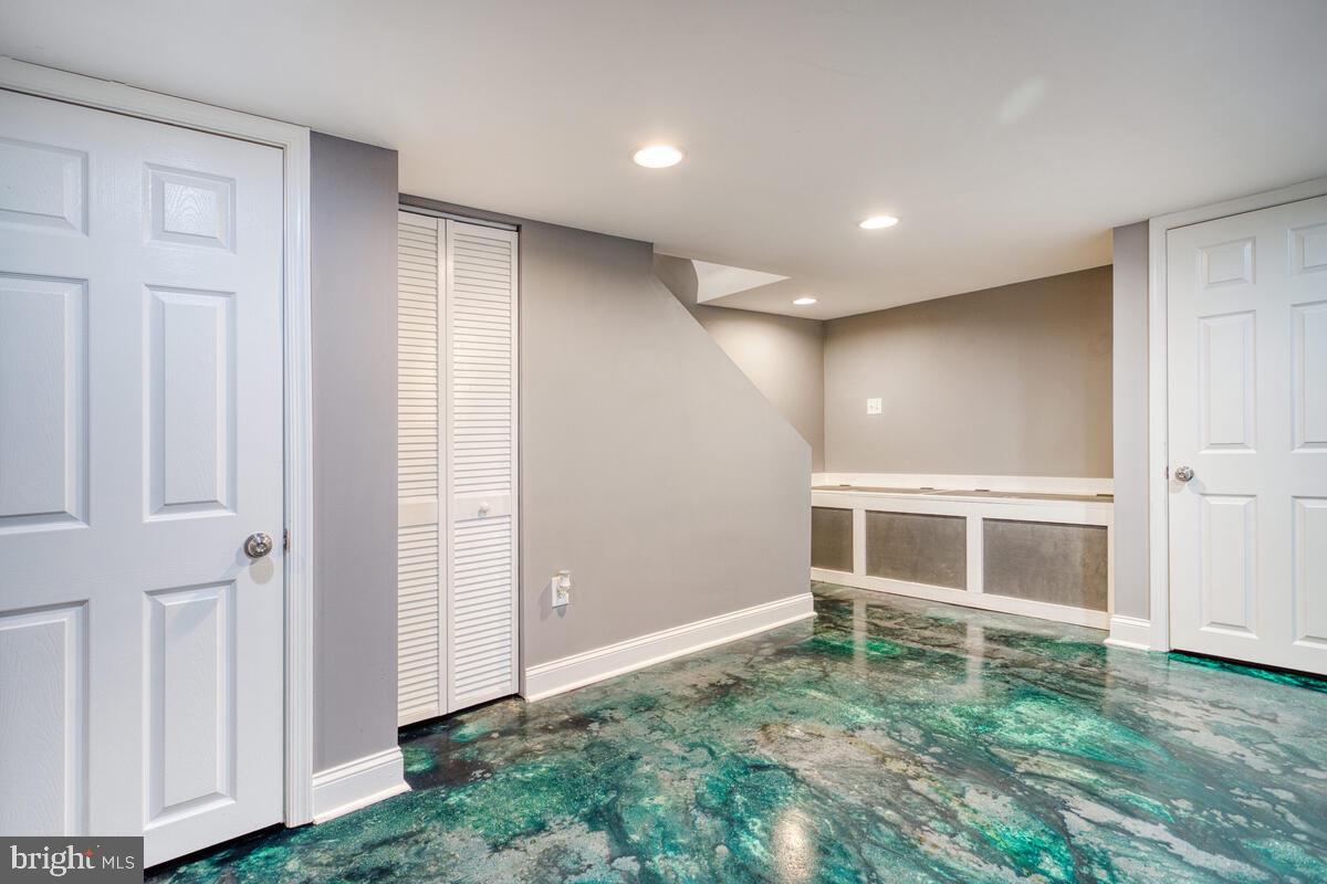 340 Gusryan Street Baltimore, MD 21224 - Photo 24 of 34 a view of an empty room with wooden floor and a window