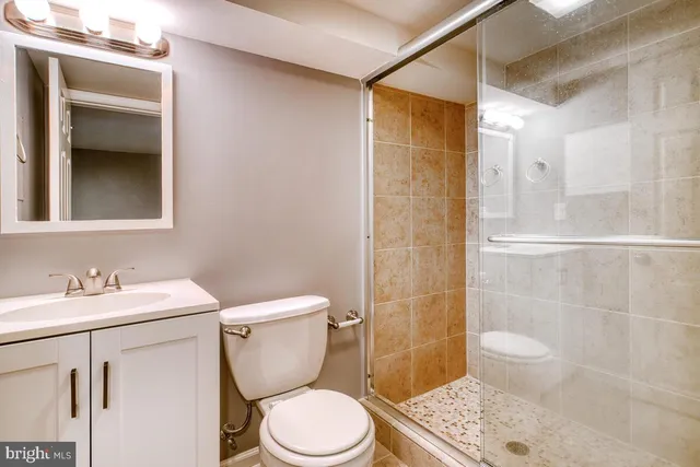 a bathroom with a toilet a sink and shower