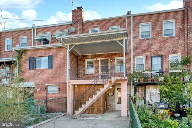 a front view of a house with plants