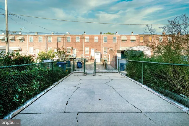 a view of a pathway with a wrought fence