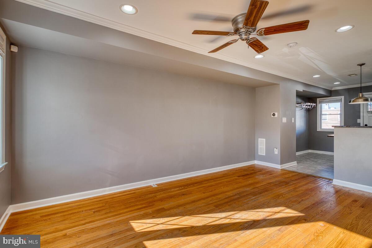 340 Gusryan Street Baltimore, MD 21224 - Photo 5 of 34 a bedroom with a bed and a chandelier