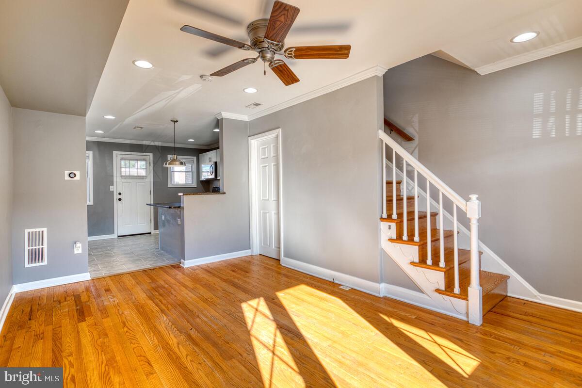 340 Gusryan Street Baltimore, MD 21224 - Photo 6 of 34 a bedroom with a bed and a chandelier