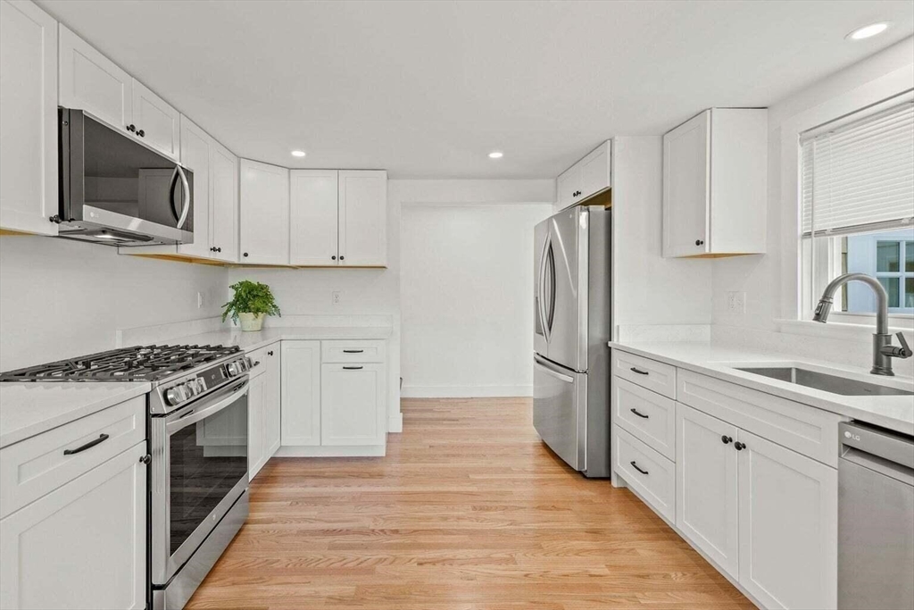 72 Forest Beach Road Chatham, MA 02659 - Photo 11 of 32 a kitchen with a stove top oven sink and refrigerator