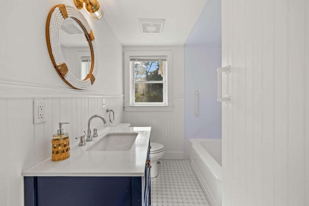 72 Forest Beach Road Chatham, MA 02659 - Photo 14 of 32 a bathroom with a sink a mirror and a window