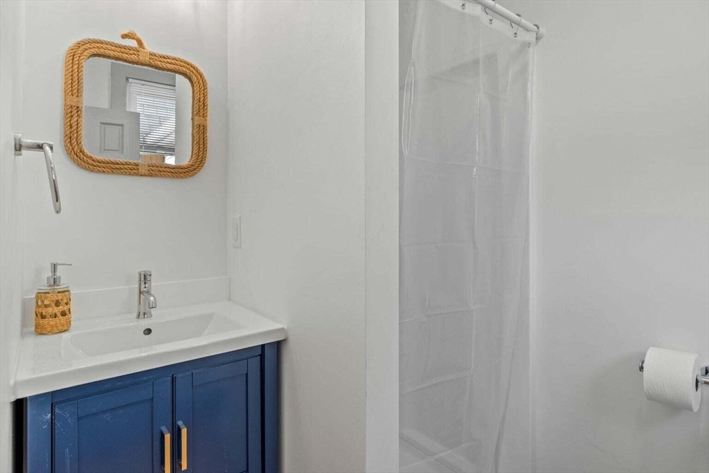 72 Forest Beach Road Chatham, MA 02659 - Photo 27 of 32 a bathroom with a sink and a mirror