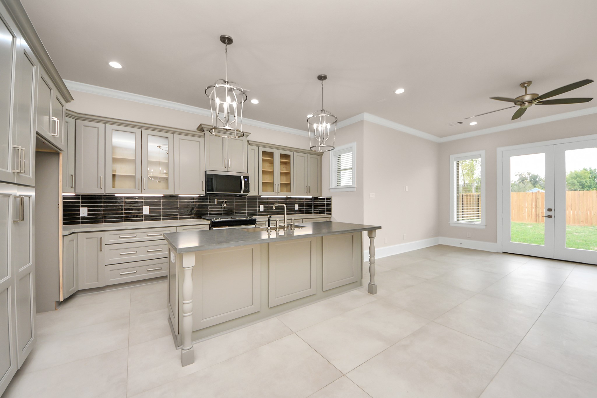 6320 Milwee Street, Unit B Houston, TX 77092 - Photo 12 of 43 a large white kitchen with granite countertop a stove a sink a refrigerator and a chandelier