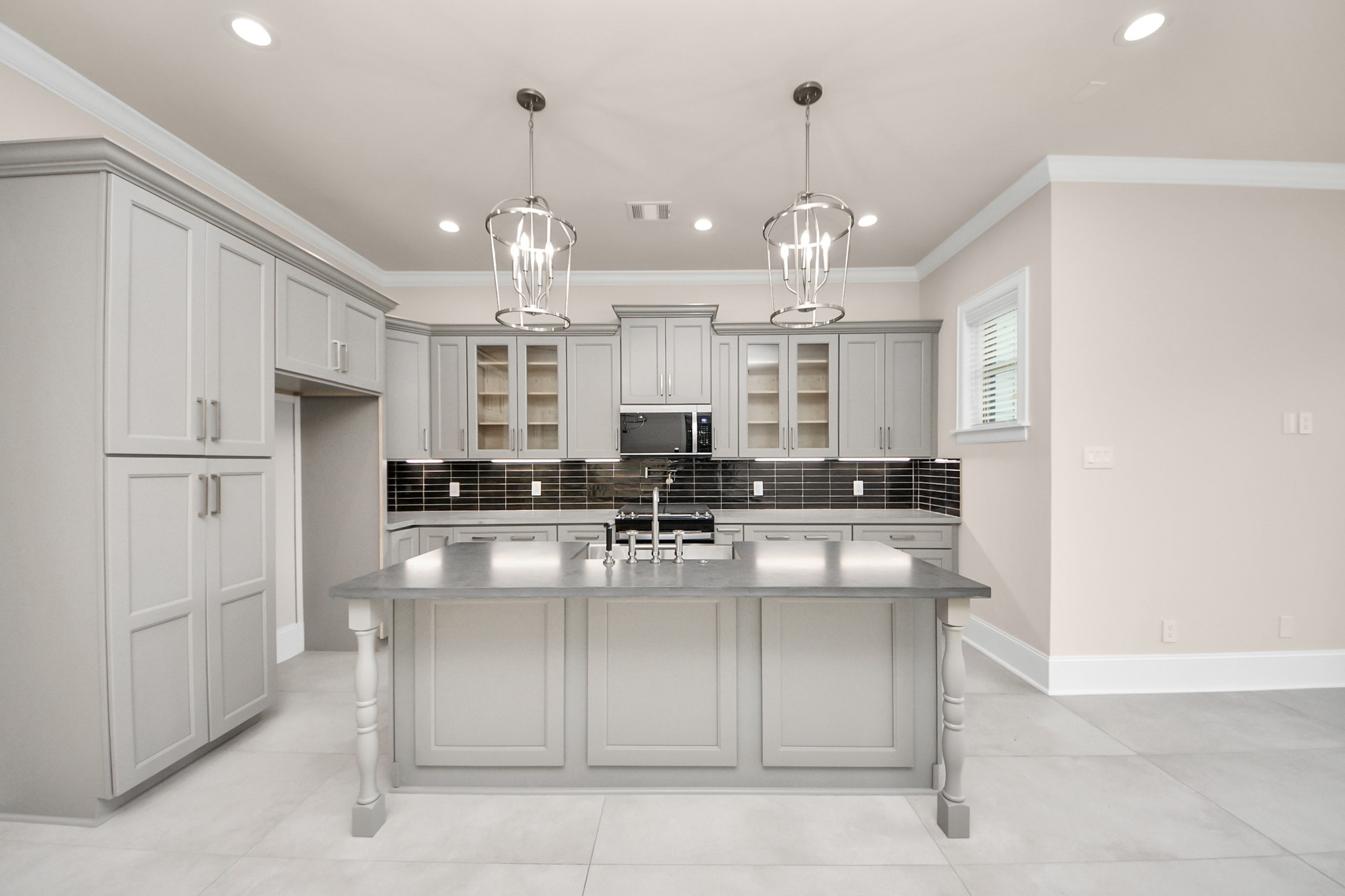 6320 Milwee Street, Unit B Houston, TX 77092 - Photo 13 of 43 a kitchen with kitchen island stainless steel appliances a center island sink and cabinets