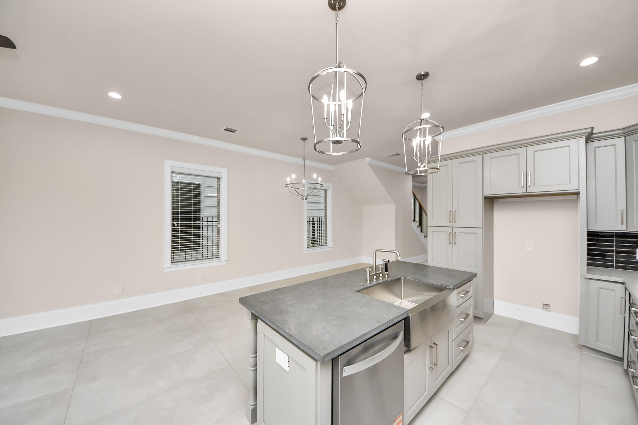 6320 Milwee Street, Unit B Houston, TX 77092 - Photo 15 of 43 a kitchen with a sink a center island and cabinets