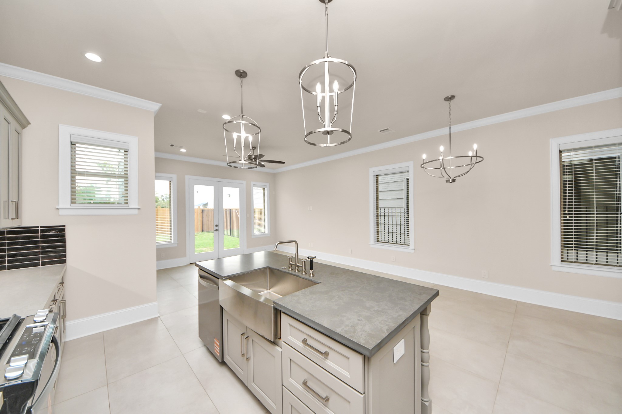 6320 Milwee Street, Unit B Houston, TX 77092 - Photo 17 of 43 a kitchen with center island a sink stainless steel appliances and windows