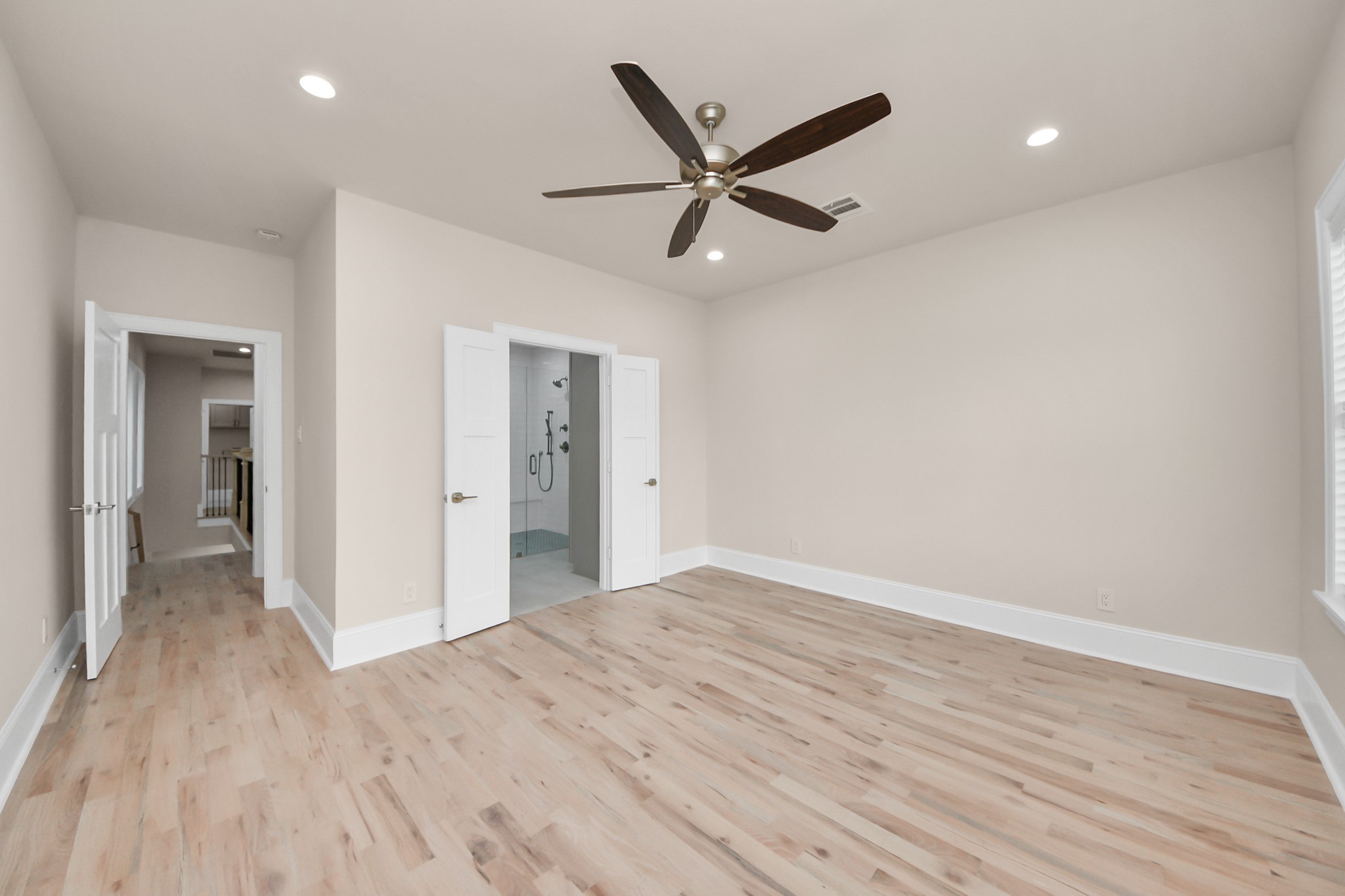 6320 Milwee Street, Unit B Houston, TX 77092 - Photo 26 of 43 a view of empty room with wooden floor and ceiling fan