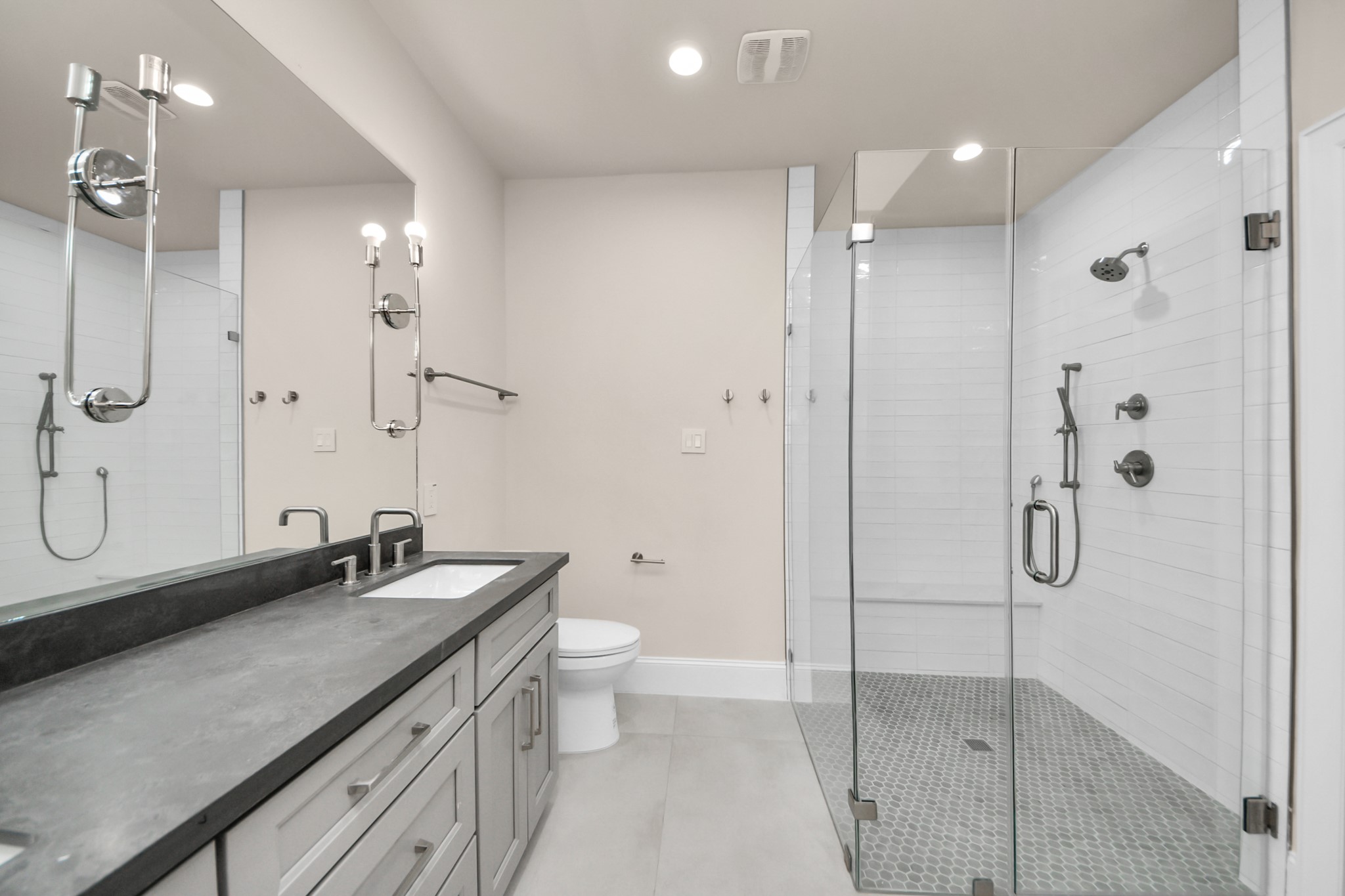 6320 Milwee Street, Unit B Houston, TX 77092 - Photo 28 of 43 a bathroom with a double vanity sink toilet mirror and shower