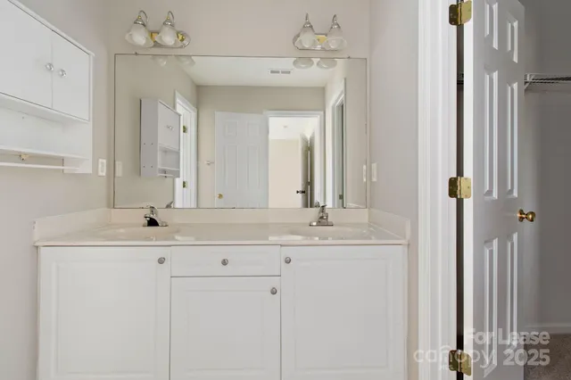 a bathroom with a sink double vanity and a mirror