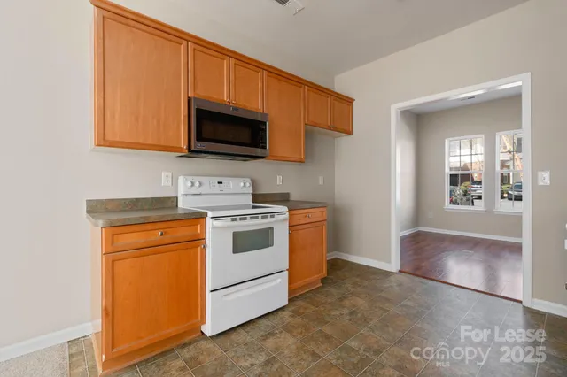 a kitchen with stainless steel appliances granite countertop a stove microwave and sink
