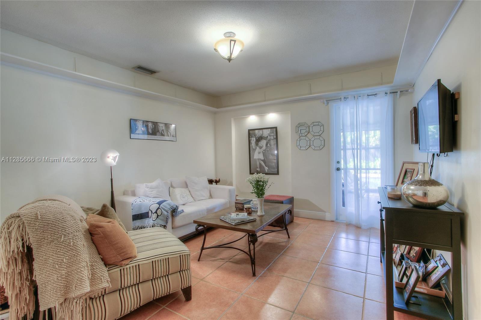 9670 Southwest 96th Court Miami, FL 33176 - Photo 12 of 21 a living room with furniture and a flat screen tv