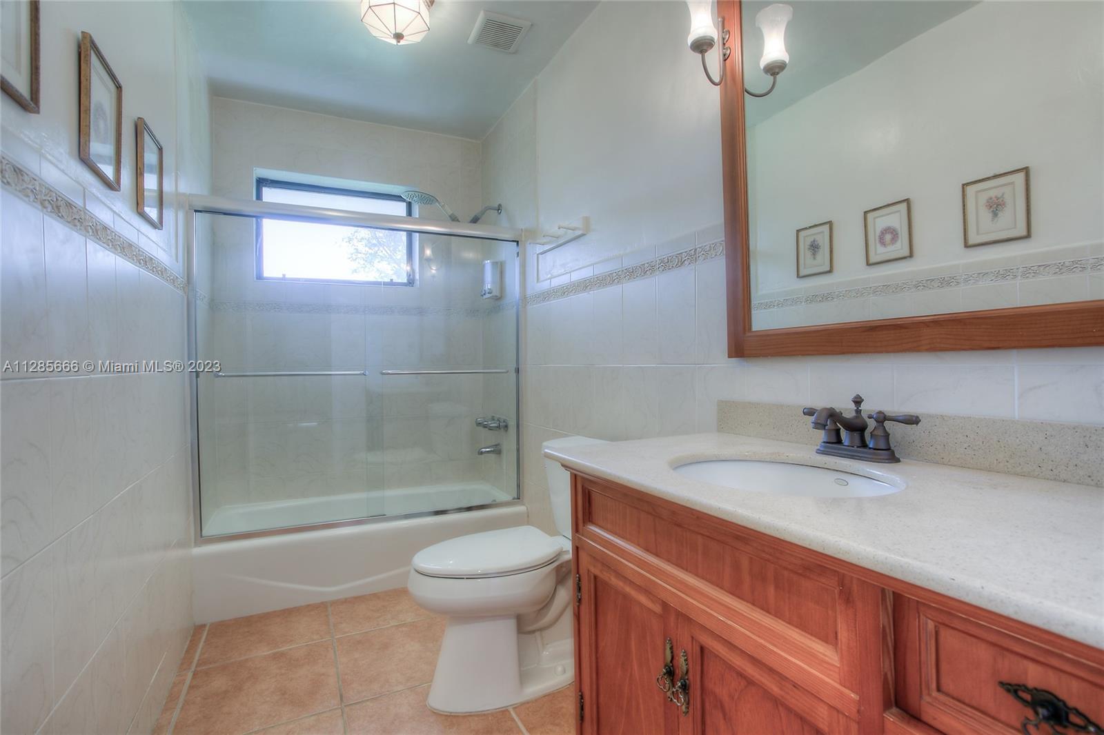 9670 Southwest 96th Court Miami, FL 33176 - Photo 14 of 21 a bathroom with a granite countertop sink a toilet a mirror and shower