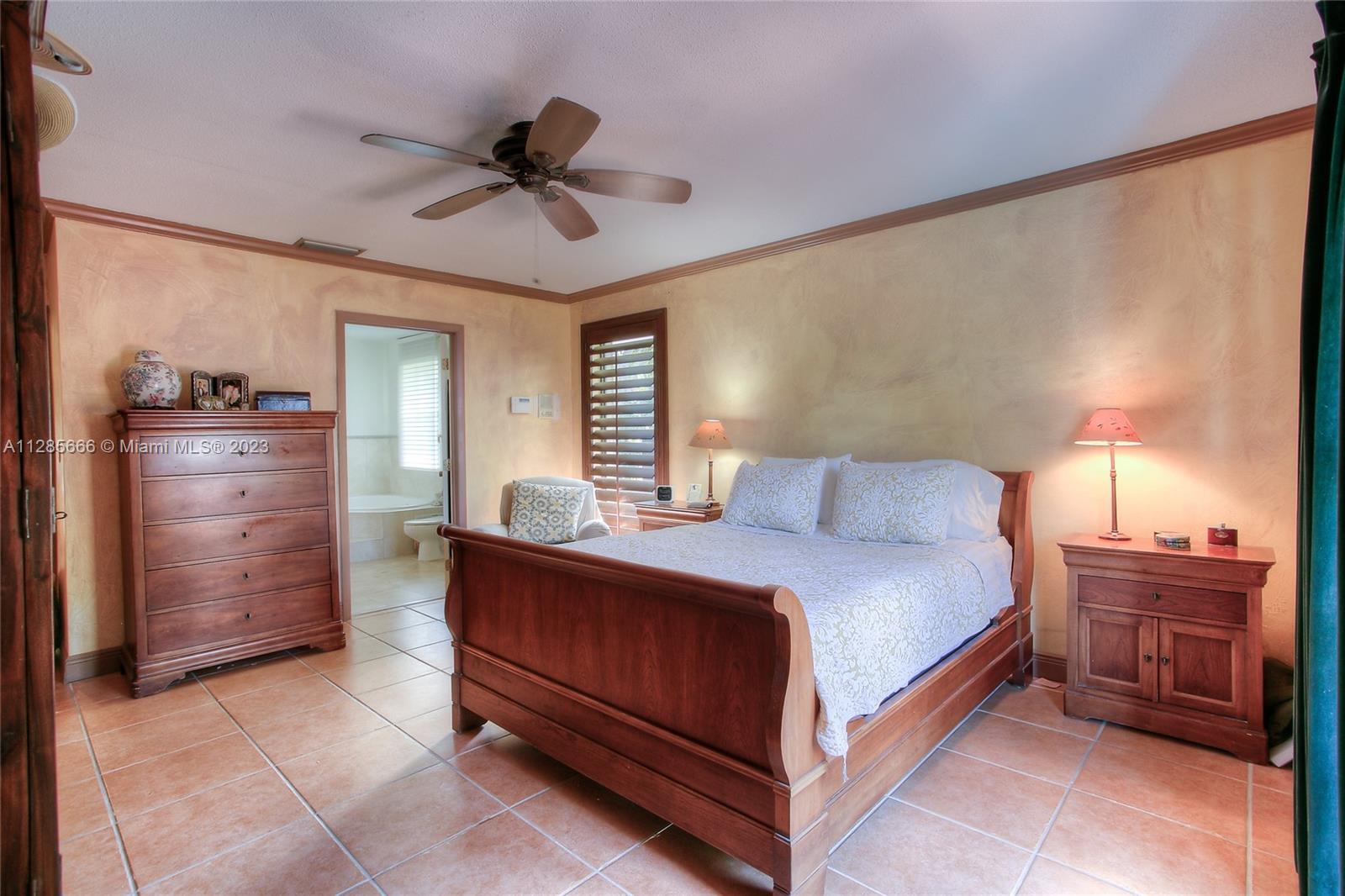 9670 Southwest 96th Court Miami, FL 33176 - Photo 16 of 21 a bedroom with a bed and a chandelier