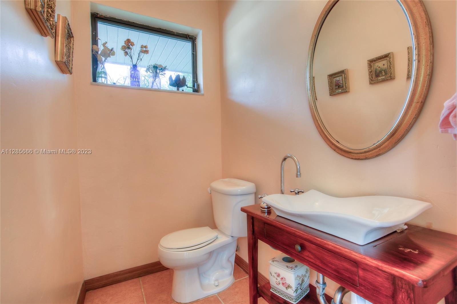 9670 Southwest 96th Court Miami, FL 33176 - Photo 18 of 21 a bathroom with a toilet a sink and a mirror