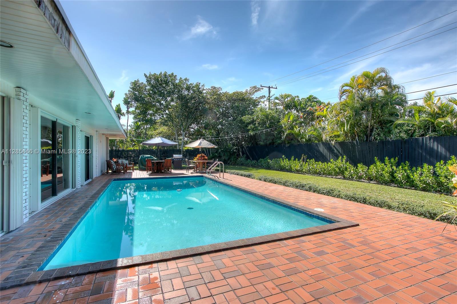9670 Southwest 96th Court Miami, FL 33176 - Photo 20 of 21 a view of a swimming pool with a patio