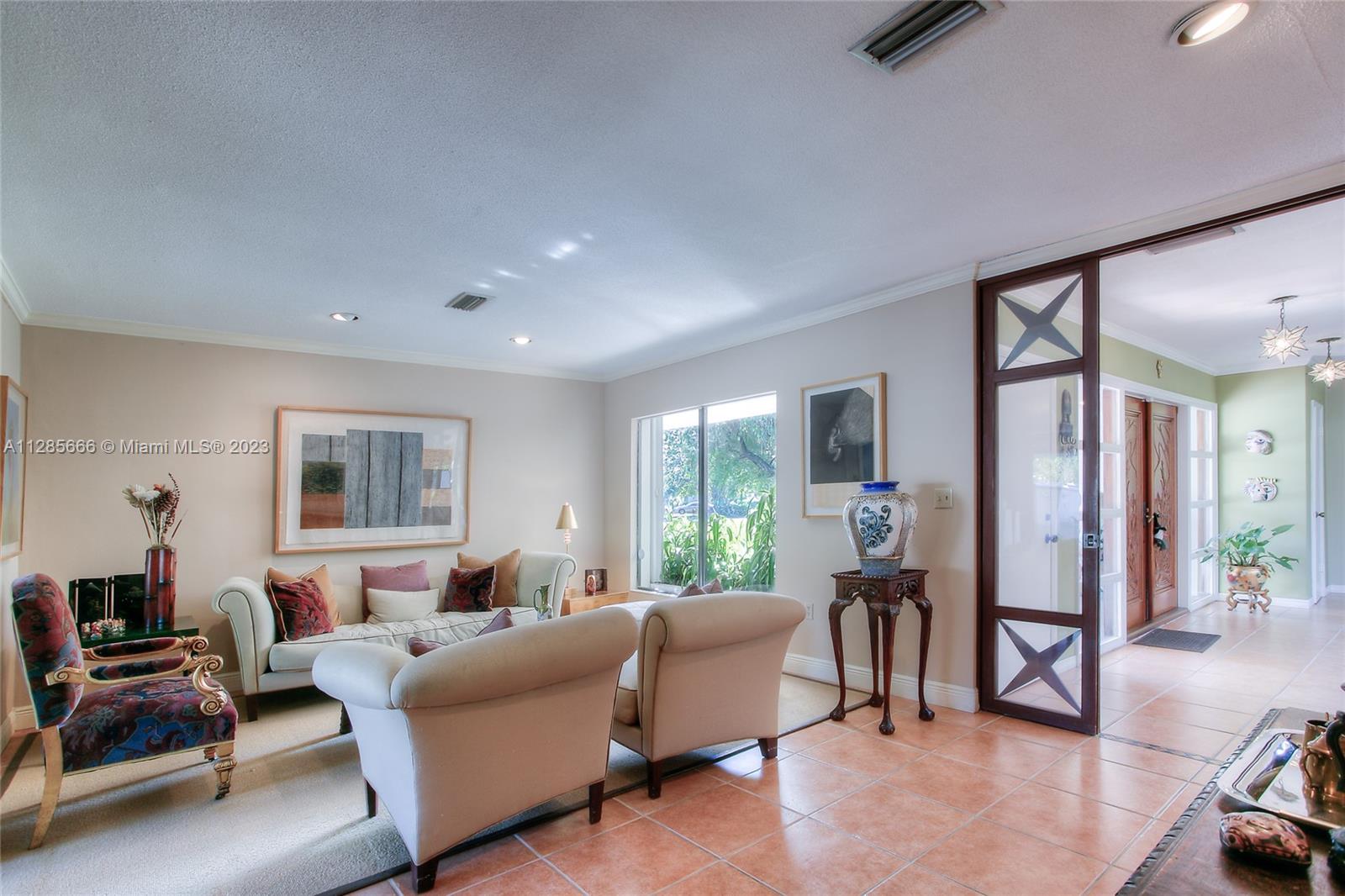 9670 Southwest 96th Court Miami, FL 33176 - Photo 3 of 21 a living room with furniture and a large window
