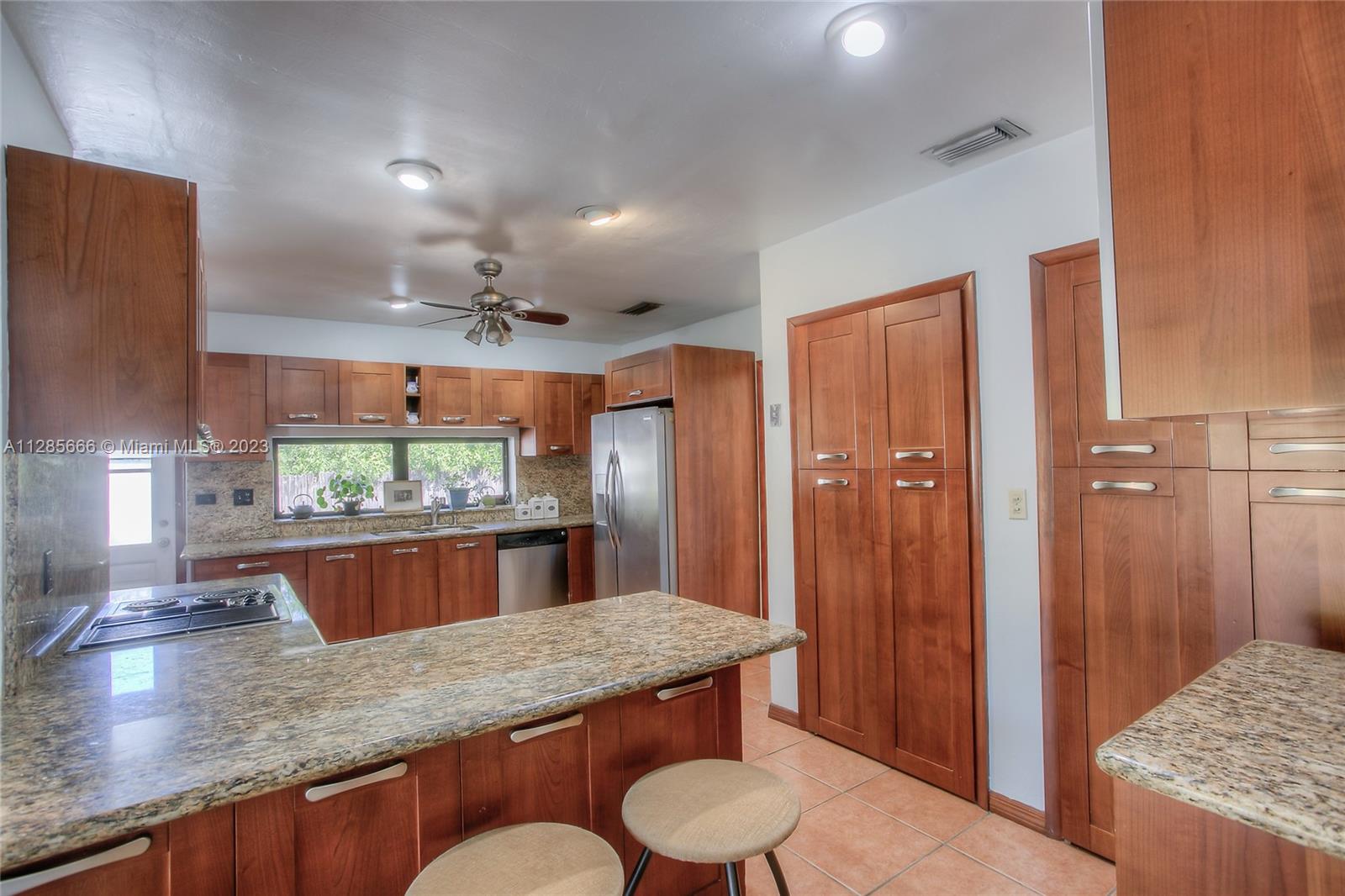 9670 Southwest 96th Court Miami, FL 33176 - Photo 5 of 21 a kitchen with a table and chairs in it
