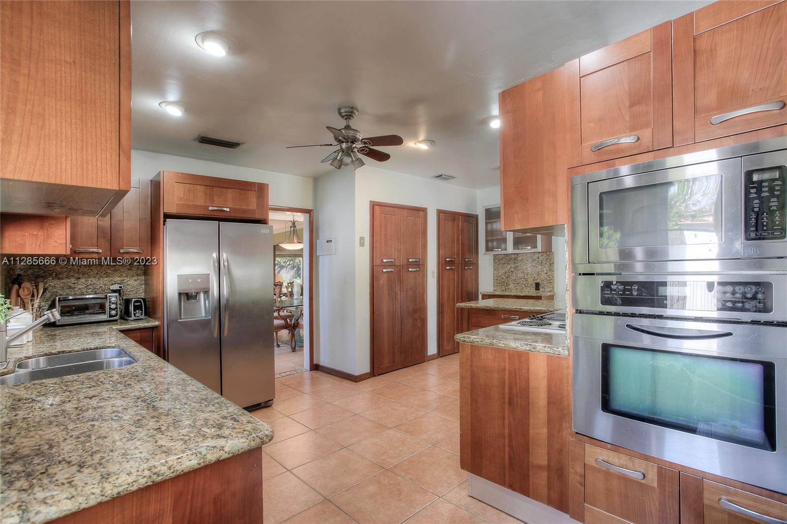 9670 Southwest 96th Court Miami, FL 33176 - Photo 6 of 21 a kitchen with stainless steel appliances granite countertop a refrigerator a oven and a sink