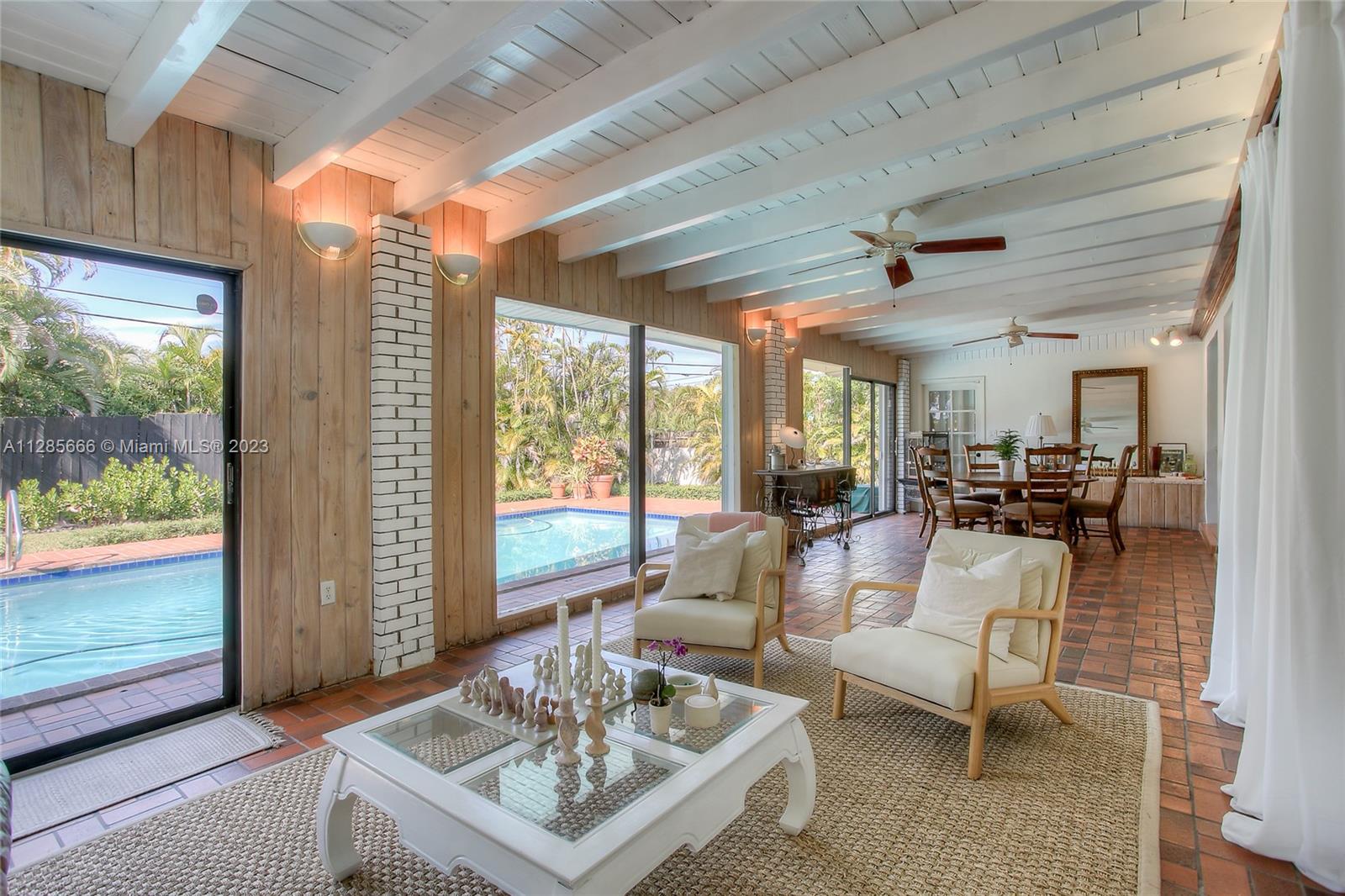 9670 Southwest 96th Court Miami, FL 33176 - Photo 8 of 21 a living room with furniture and a large window