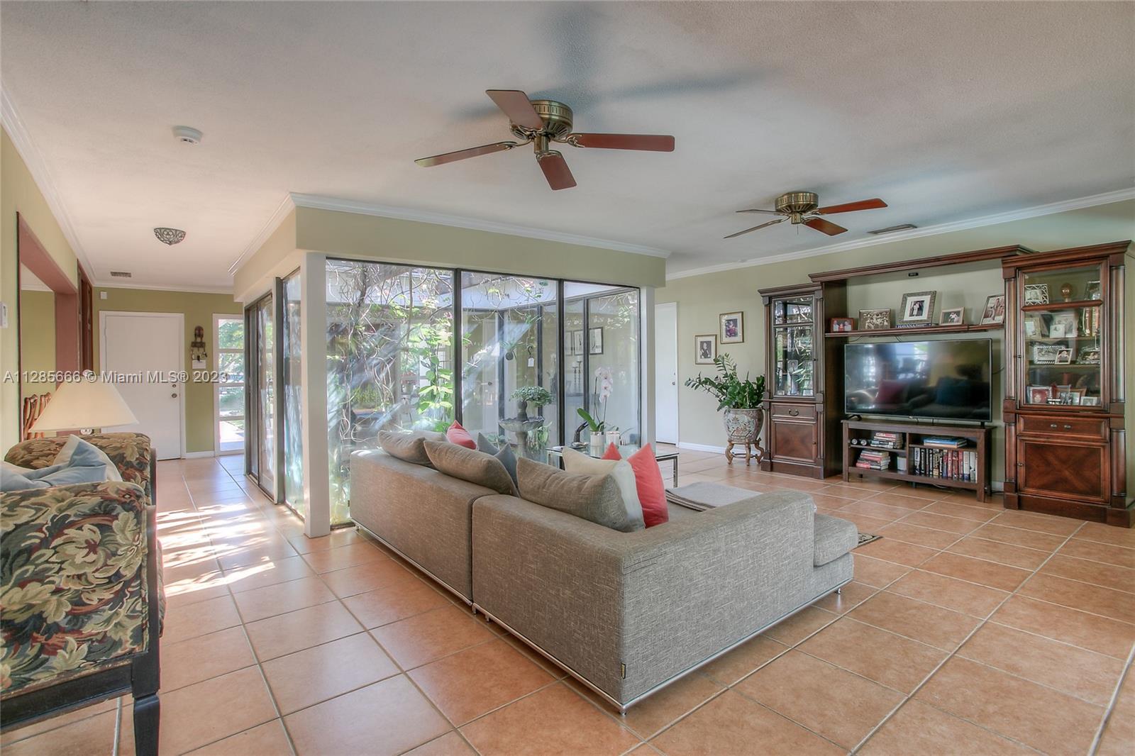 9670 Southwest 96th Court Miami, FL 33176 - Photo 10 of 21 a living room with furniture and a flat screen tv