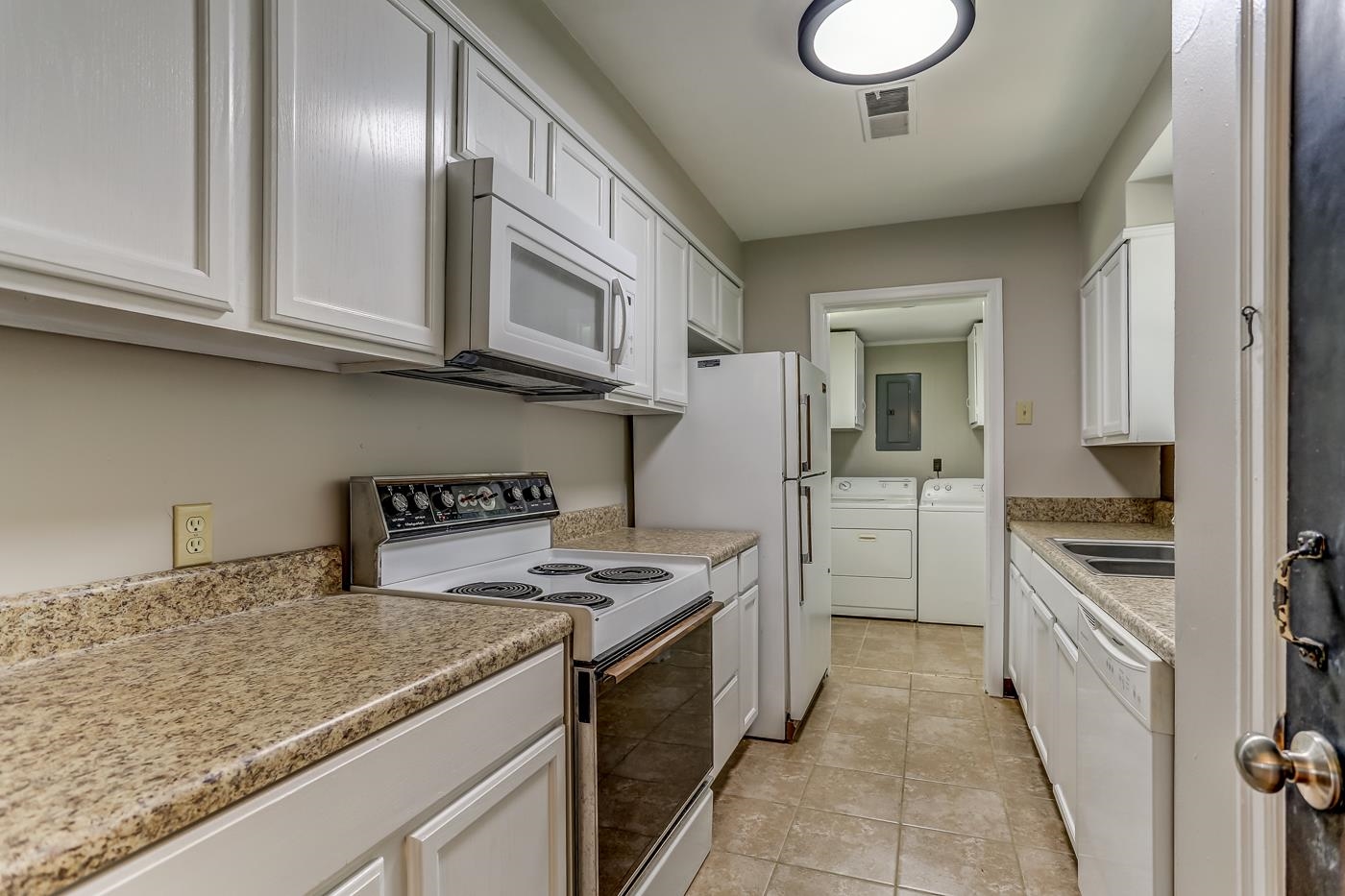 4578 Sea Isle Road Memphis, TN 38117 - Photo 10 of 19 a kitchen with stainless steel appliances granite countertop a sink stove and refrigerator