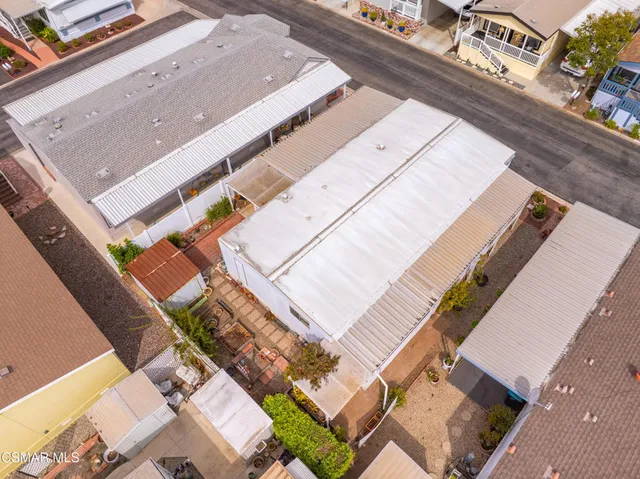 an aerial view of residential houses with outdoor space and swimming pool