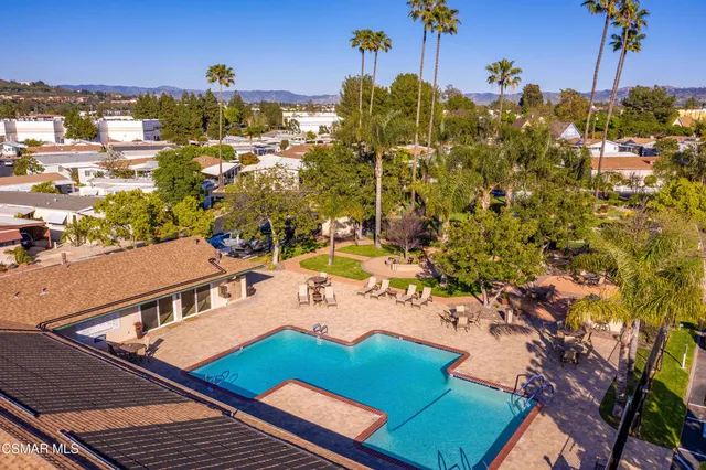 a room with pool table and windows