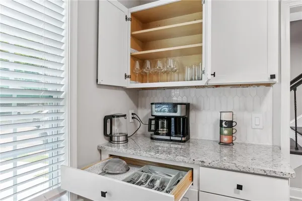 a kitchen with granite countertop a sink and a stove